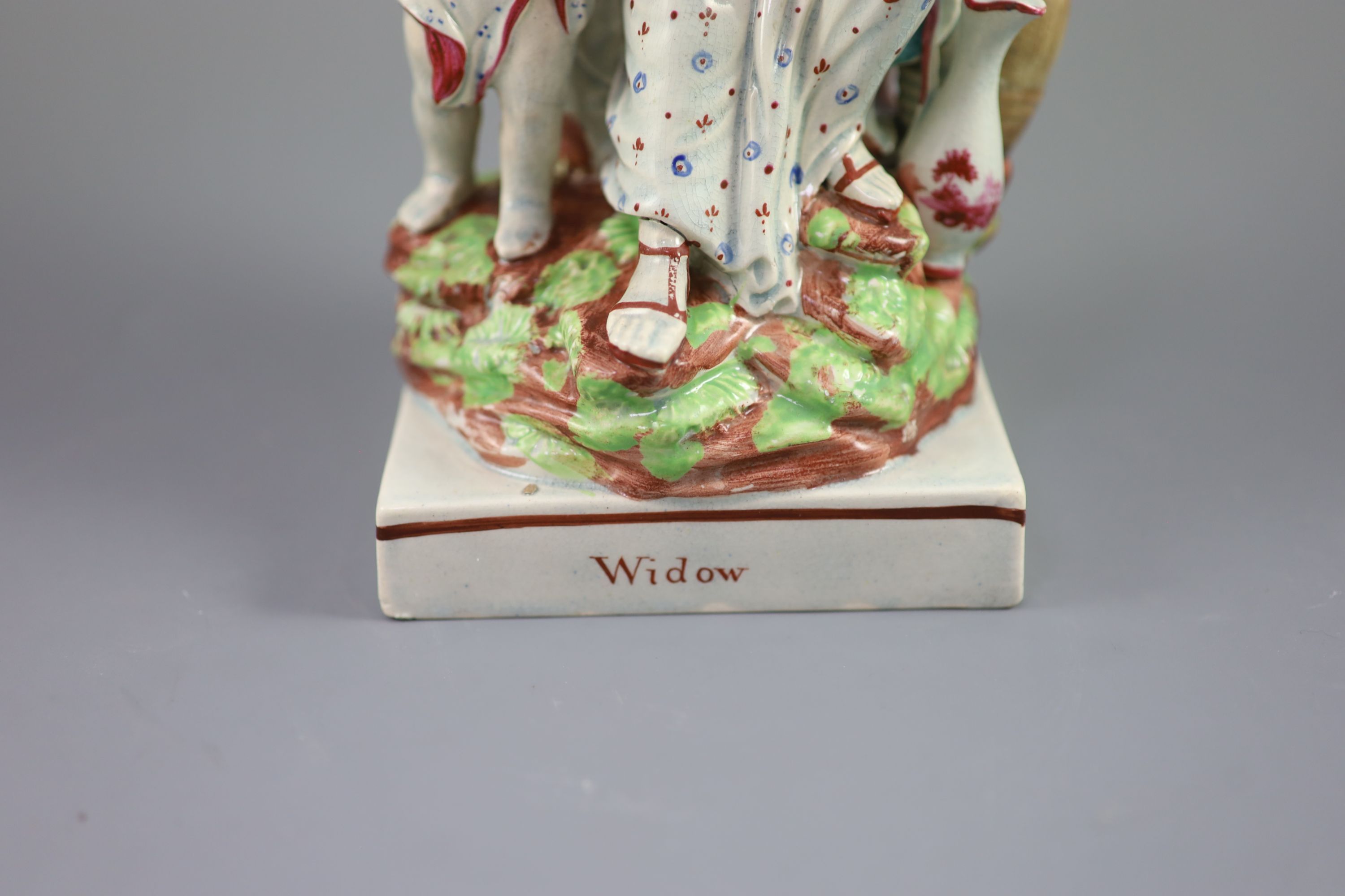 A Ralph Wood type group of a widow of Zarepeth with oil and barrel, c.1790-1810, 27.5cm high